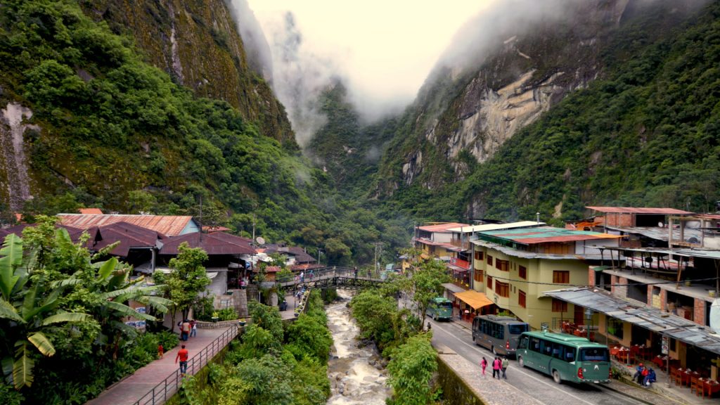 Aguas Calientes surrounded by cloud-covered nature, a highlight in the Aguas Calientes Guide - Xplor Machu Picchu