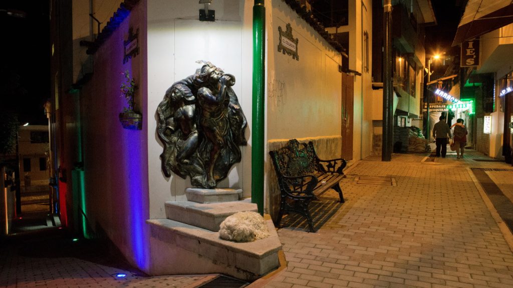 Andean-style sculpture on a quiet street at night in Aguas Calientes, featured in the Aguas Calientes Guide - Xplor Machu Picchu