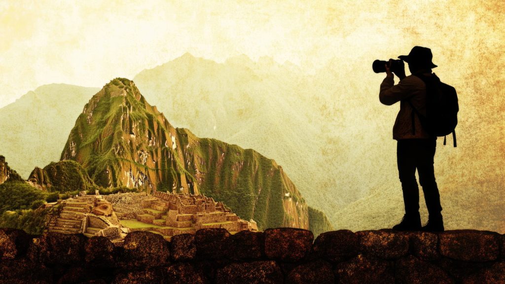 Photographer capturing the classic Machu Picchu view at sunset, a great example in Photography Tips Machu Picchu - Xplor Machu Picchu